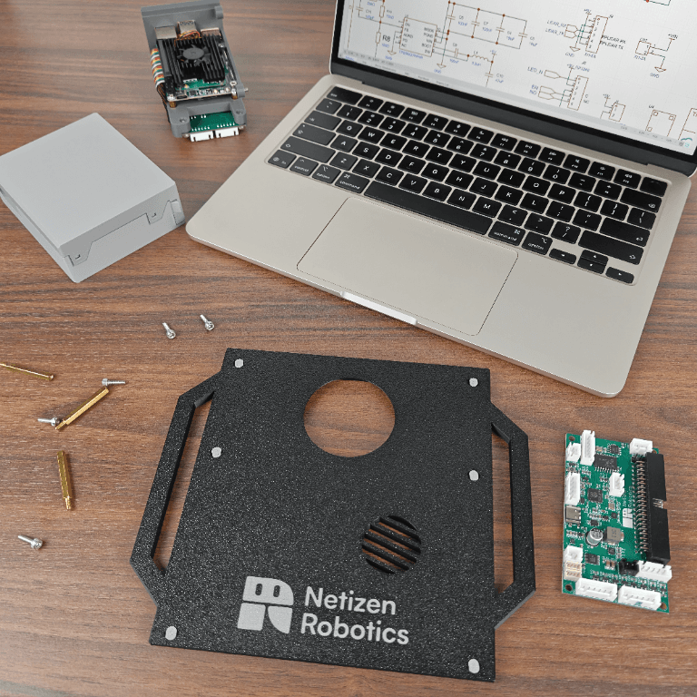 Workbench with Netizen Robotics components and circuit boards
